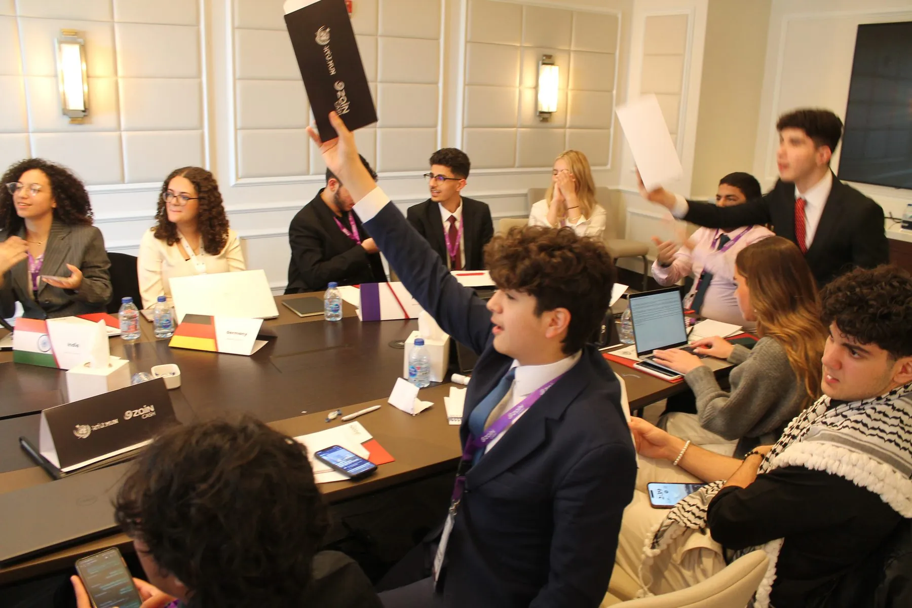 HTUMUN delegate taking notes during debate